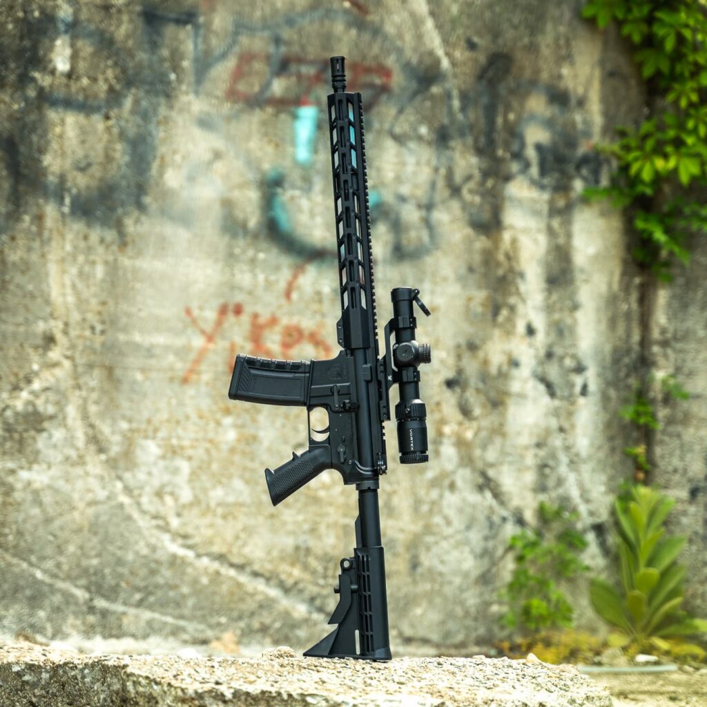 A black One Horse AR-15 rifle with a Vortex optic, standing upright against a weathered concrete wall.