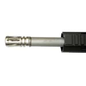 Close-up of a firearm barrel with a muzzle brake, showcasing precision engineering and durable materials.