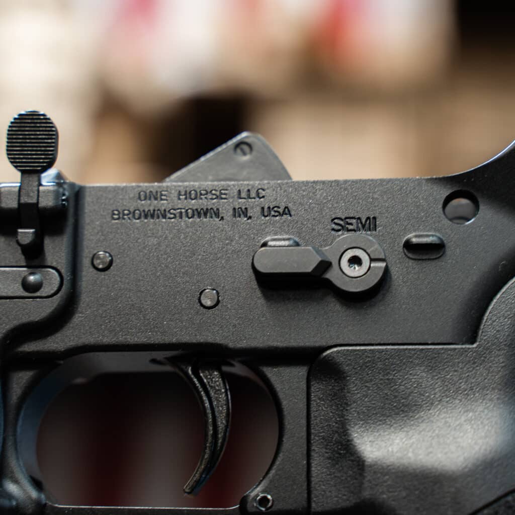Close-up of a One Horse lower receiver marked One Horse LLC, Brownstown, IN USA.