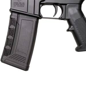 Close-up of a black AR-15 rifle grip and trigger, showcasing textured surfaces and model details.
