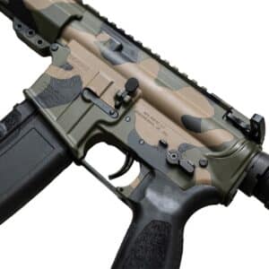 Close-up of a One Horse American-made rifle featuring a durable multi-color camouflage finish, black polymer magazine, and precise metal construction.