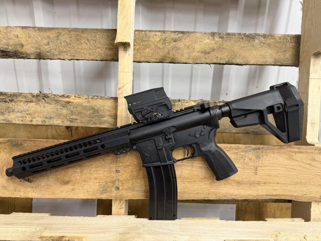 A black American-made One Horse rifle with a Vortex AMG UH-1 holographic sight, featuring a modular handguard and a tactical pistol brace.