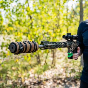 300 blackout suppressor on an AR-15 in the woods with heat cover
