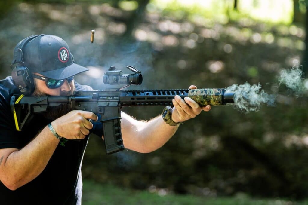 One Horse SD AR pistol with a camo-wrapped suppressor firing at the range