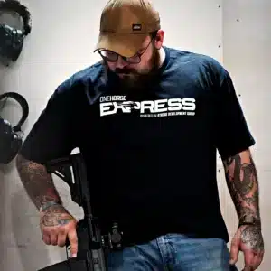 Man wearing the black One Horse Express t-shirt in the shop